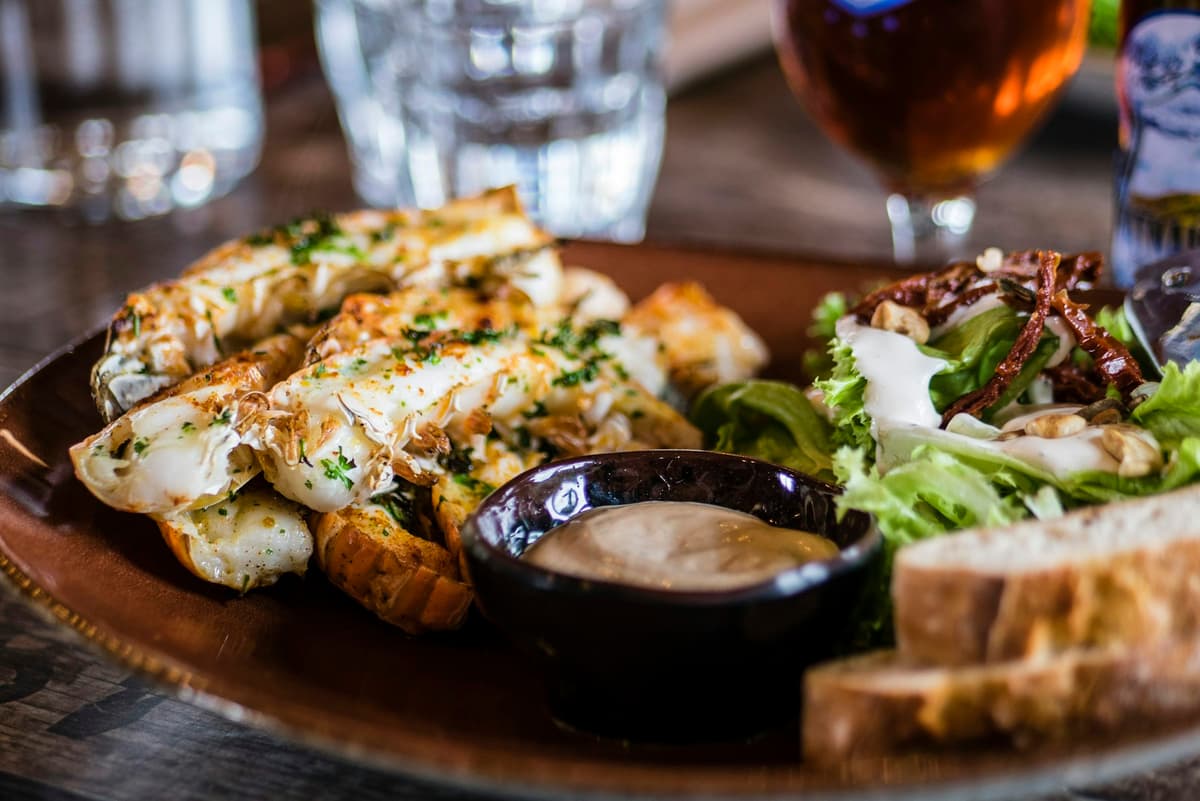 Grilled seafood platter with salad and dipping sauce